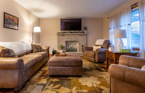 Cozy relaxing living room with decorative fireplace and smart TV