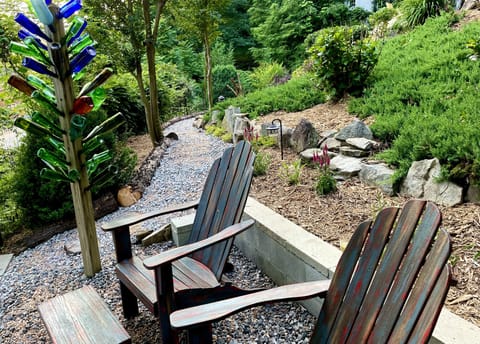 A couple of chairs down by the road, with a view of the river.