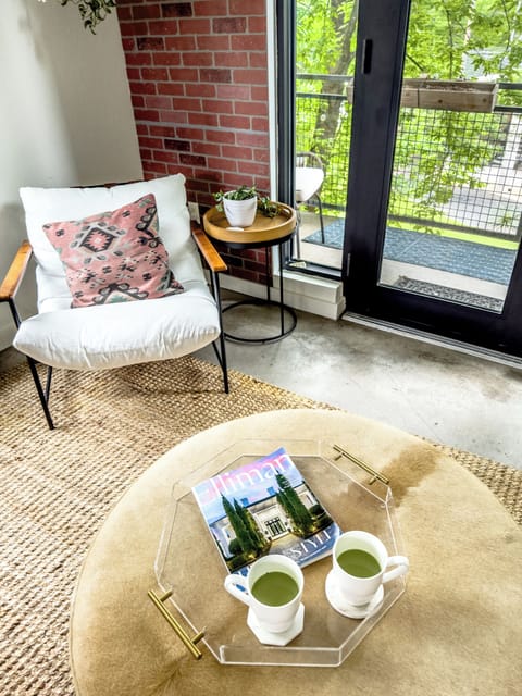 Sip tea while enjoying urban views from this stylish nook with vibrant decor!