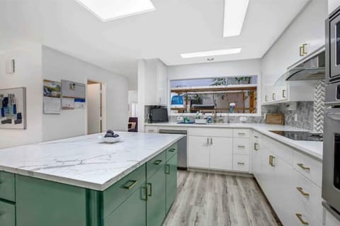 Big kitchen with views into living room and atrium