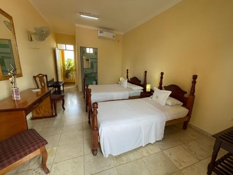 Comfort Room, Multiple Beds, Private Bathroom, City View | In-room safe, laptop workspace, free WiFi
