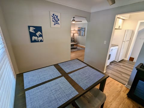 Dining room between featuring a high top table with 4 padded stools.
