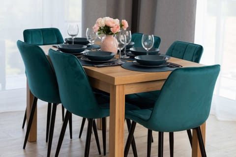 A beautifully arranged dining table with blue chairs, ready for a meal.