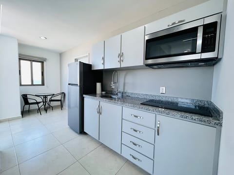 Apartment | Private kitchen | Full-size fridge, microwave, blender, cookware/dishes/utensils