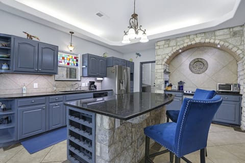 Closer view of the kitchen and bar seating.