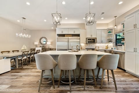 Kitchen & dining area can accommodate 18 guests, open to living and game rooms.