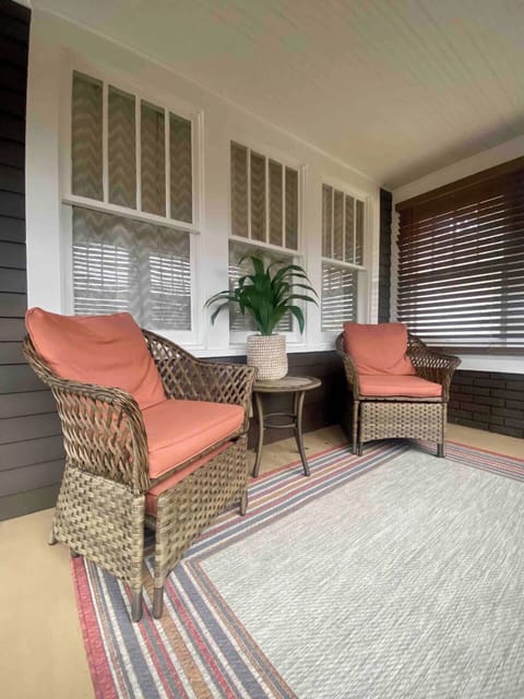 You’ll be greeted by a charming enclosed porch with seating to relax and enjoy the quiet neighborhood with privacy. 