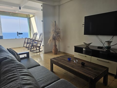 Deluxe Apartment, 2 Bedrooms, Balcony, Sea View | Living room | 50-inch Smart TV with digital channels, TV