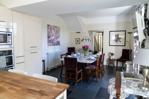 Modern kitchen and dining area equipped with high-end brands such as Le Creuset.