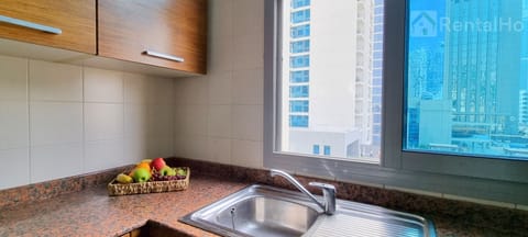 Full-size fridge, highchair, cookware/dishes/utensils, cleaning supplies