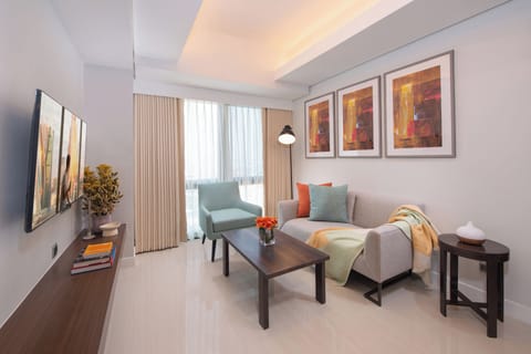 Deluxe Suite, 2 Bedrooms | Living area | Flat-screen TV