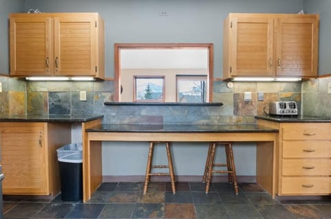 The built-in table located in the kitchen is a cozy spot to grab a snack or hang out while keeping the chef company.