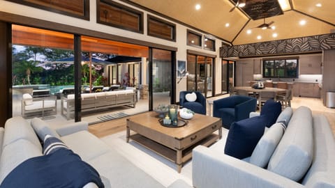 Expansive living space with open air views of the pool