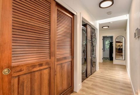 Hall way closet and double washer dryer combo.