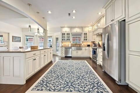 To the right, entertain your crew in our large, fully stocked kitchen.