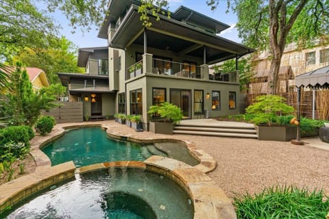 Five Star Backyard Oasis with Multiple sitting areas, and heated pool with cascading waterfall from spa.