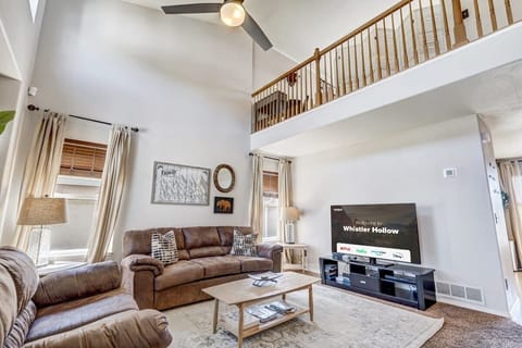 Our Living Room Boasts a Smart TV, Cozy Couches and Chairs, Warm Lamps, and Expansive Windows for Natural Light and Breathtaking Views.