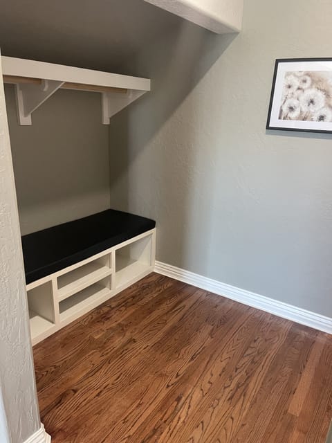 Upstairs open closet with bench
