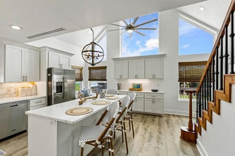 Bright, modern kitchen with high ceilings, chic decor, and ample natural light!