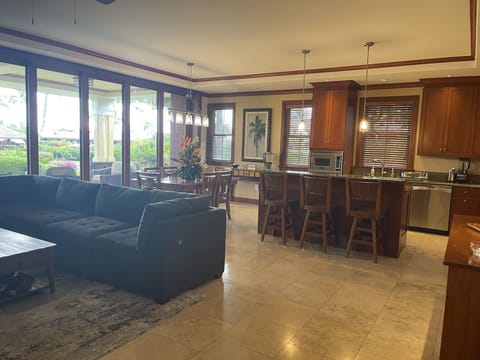 Kitchen & living area. Dining table seats 6 with full L shaped couch & smart TV.