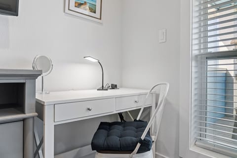 Desk in the king bedroom can be used as a vanity or for remote work or school.