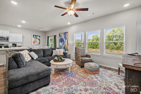 Living room with tall ceilings, lots of light and open concept!