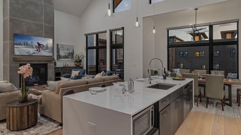 Kitchen looking into great room and deck access