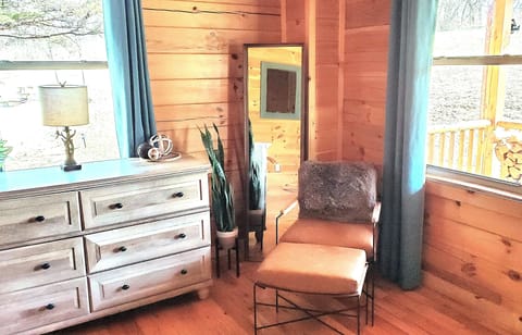 Main floor primary suite is a private respite with comfy seating and soft lights