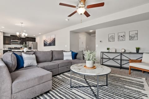 Cozy sectional sofa, 65" TV, base green accent wall