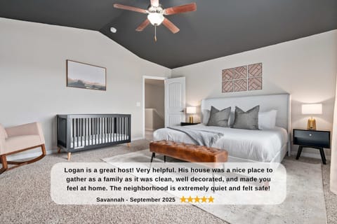 Master bedroom with king bed, crib bed, 50" TV and attached bathroom.