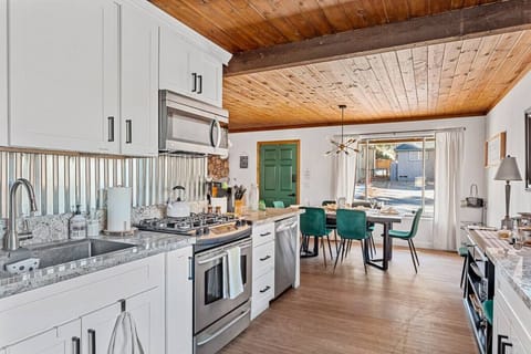 Gather around! Our cozy dining table by the kitchen is perfect for family meals and lively conversations.
