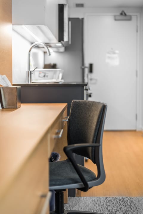 Signature Studio | Desk, laptop workspace, blackout drapes, iron/ironing board