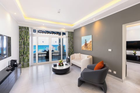 Junior Suite, 1 King Bed, Beach View | Living area | 52-inch LED TV with satellite channels, fireplace