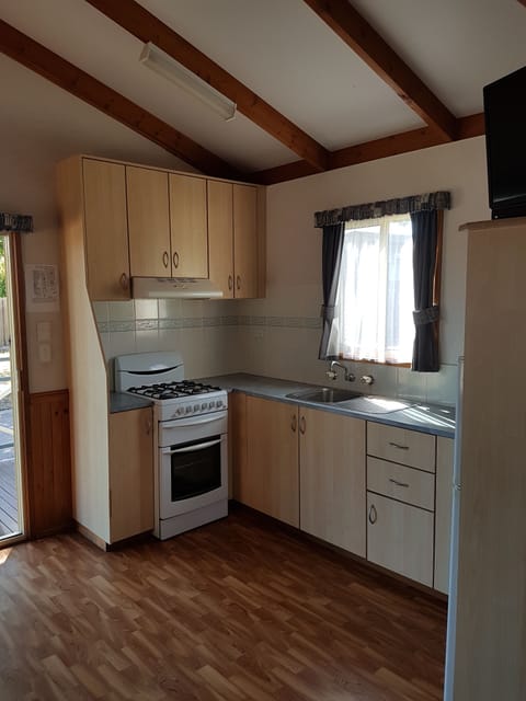 Two Bedroom Deluxe Cabiin | Private kitchen | Fridge, microwave, oven, stovetop