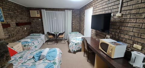 Classic Triple Room, Multiple Beds, Non Smoking, Ground Floor | Laptop workspace, blackout drapes, iron/ironing board, bed sheets