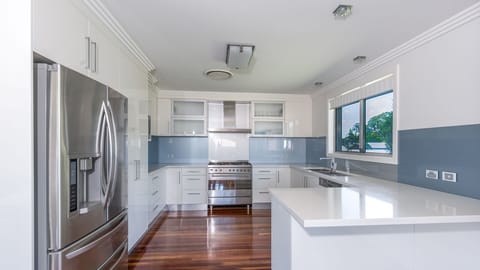 Deluxe Beach House | Private kitchen | Fridge, microwave, stovetop, electric kettle