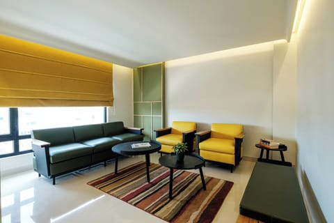 Urban Suite | Living area | 43-inch LCD TV with cable channels, books