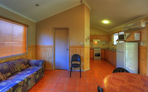 Deluxe Cabin | Living area | Flat-screen TV, DVD player