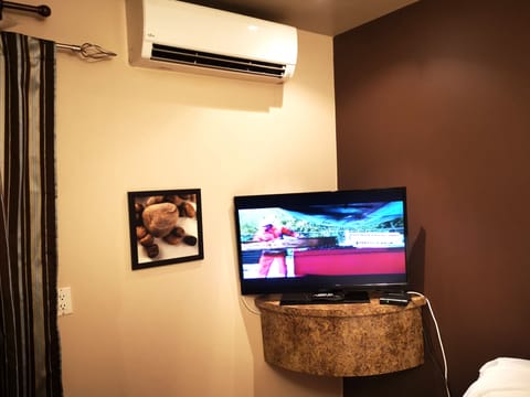 Room, 2 double beds separated by a wall, in 2 small units | Living area | 32-inch LCD TV with cable channels, TV