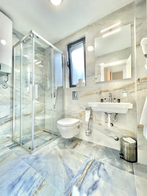 Comfort Room | Bathroom | Shower, rainfall showerhead, designer toiletries, hair dryer