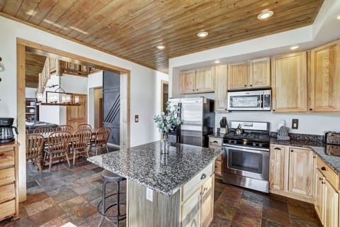 Modern kitchen with granite counters and full appliances.