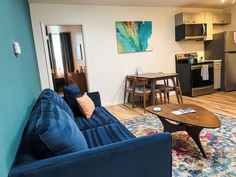 Our living room is tastefully decorated with a mix of modern and contemporary accents. You'll find vibrant art pieces adorning the walls, complemented by carefully chosen decorative items that create a warm and welcoming ambiance.