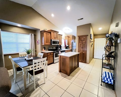With our spacious kitchen island! The perfect spot to prep meals, enjoy a casual bite, or sip a glass of wine while chatting with friends.