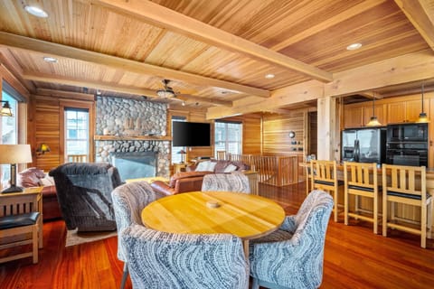 Relax together in the living room on plush leather sofas around the river rock fireplace or enjoy watching the surf from oak Morris rockers.