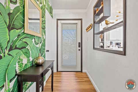 Tropical-inspired entry with chic decor and warm, natural light-filled charm.