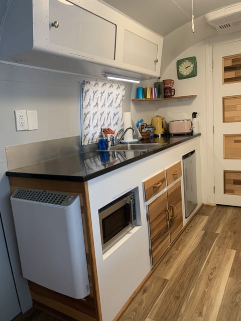 Galley with microwave, fridge, small appliances. Grill is just outside.