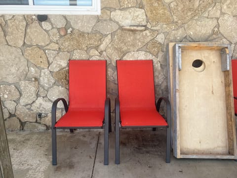 Covered seating and cornhole game