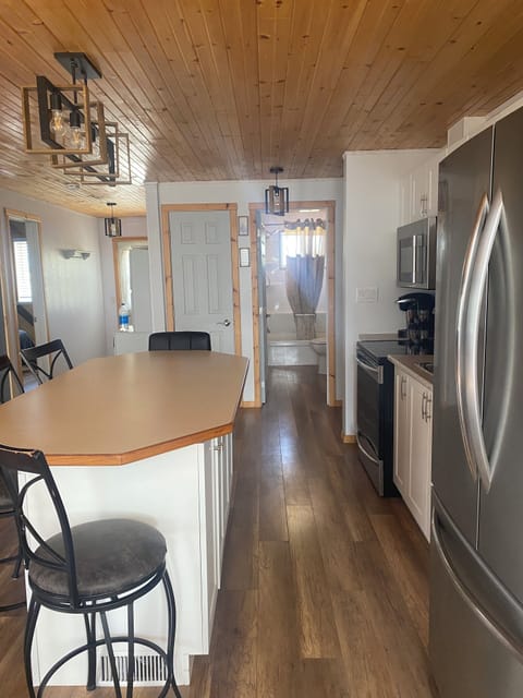 New dishwasher installed in 2025 behind grey door by bathroom
