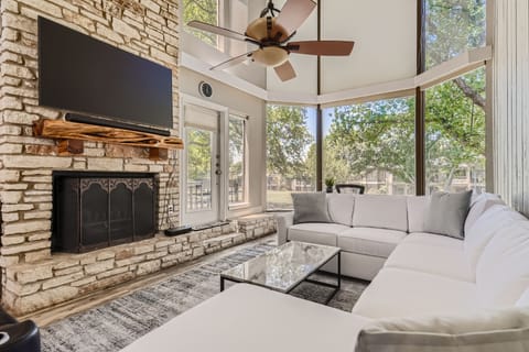 Your bright living room has a beautiful stone fireplace.