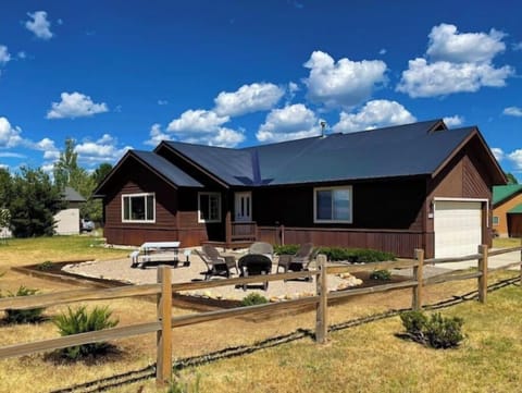 Front view. Picnic table seating & firepit area.